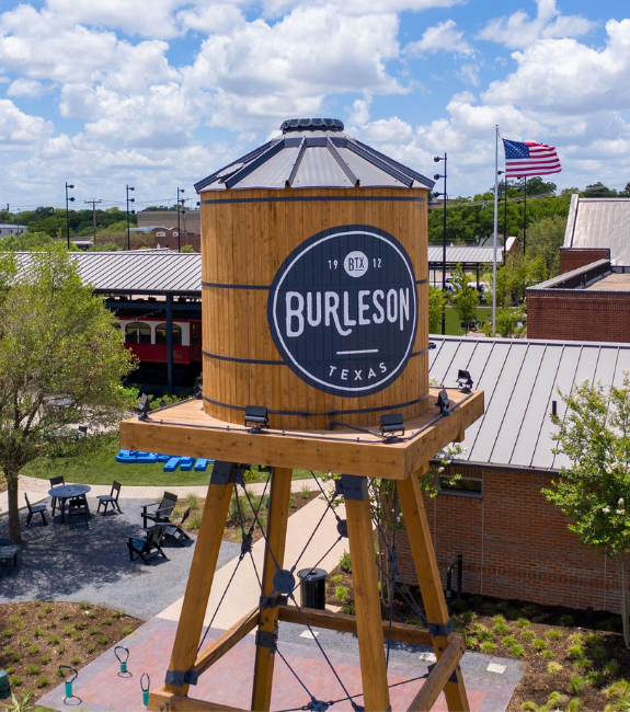 Burleson TX water tower near Old Town Burleson representing local service area for Texas Tough Waste dumpster rentals