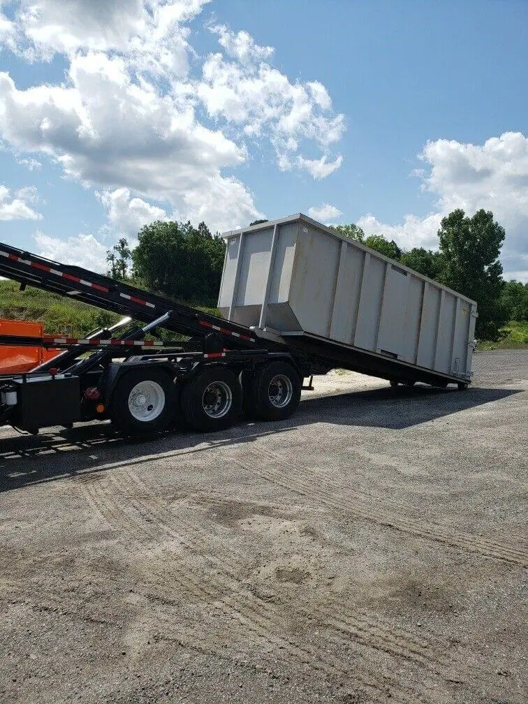 Texas Tough Waste roll-off dumpster rental delivery truck serving contractors and commercial projects