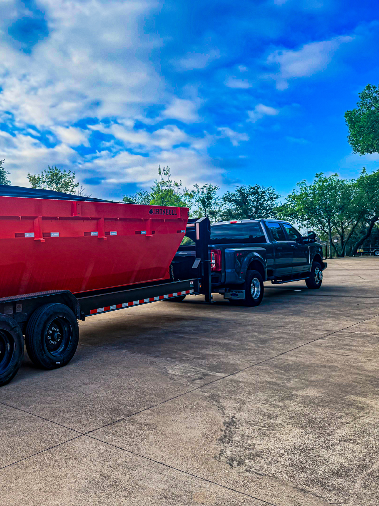 Texas Tough Waste dumpster trailer and truck in Aledo, TX for construction debris removal, roofing projects, and cleanup jobs